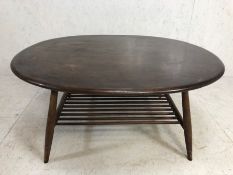 Ercol, Mid century Oval Ercol coffee table on tapered legs with magazine shelf ,approximately,