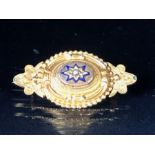 Victorian Gold coloured mourning brooch with central star design and a single seed pearl, the gold