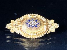 Victorian Gold coloured mourning brooch with central star design and a single seed pearl, the gold