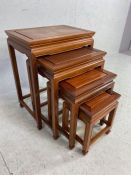 Oriental style carved wooden nest of four occasional tables