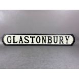 Modern wooden sign, 'GLASTONBURY'', in the form of a cast iron road sign, approx 85cm in length