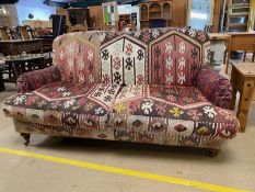 Kilim sofa, 2 seater sofa upholstered in sections of kilim rugs, on wooden legs, approximately 167cm