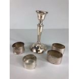 Silver napkin rings, 4 silver napkin rings and a small silver candle stick all A.F, approximately