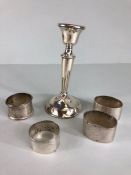 Silver napkin rings, 4 silver napkin rings and a small silver candle stick all A.F, approximately