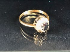 9ct Gold ring set with central large faceted gemstone and surrounded by diamonds size approx 'T'