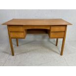 Mid century style four drawer desk in light wood veneer, approx 122cm x 61cm x 73cm