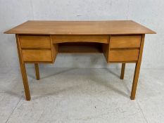 Mid century style four drawer desk in light wood veneer, approx 122cm x 61cm x 73cm