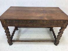 Heavily carved plank top refectory table on heavy barley twist legs with carved flora and fauna