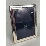 Hallmarked silver photo frame with blue silk backing in original box approx 16 x 21cm
