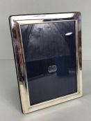 Hallmarked silver photo frame with blue silk backing in original box approx 16 x 21cm