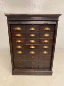 Vintage haberdashery chest / cabinet, the tambour front concealing twenty four drawers with brass