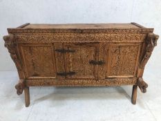 Carved indian dowry chest on splayed legs with floral carvings and horse and princess carvings, door