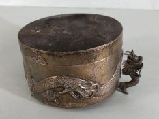 A Silver Chinese lidded pot with raised dragon decoration underside stamped 'WH' 90 with character