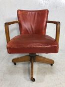 Captains Chair, 20th century swivel captains chair, light wood frame upholstered in Faded Red