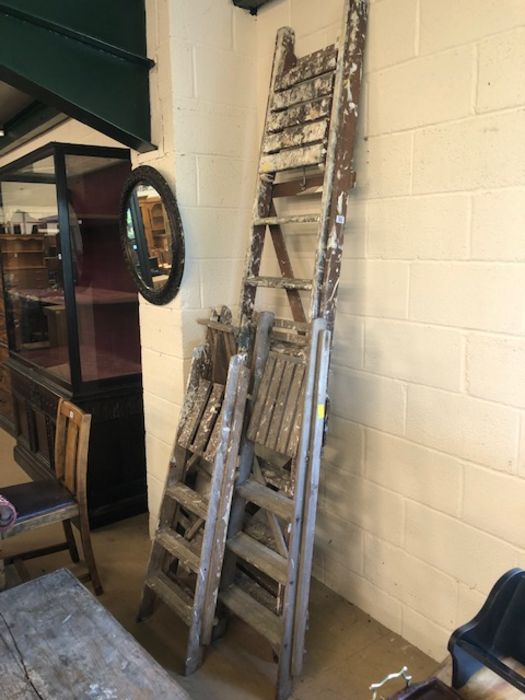 Four vintage wooden step ladders, useful for decorative or shop display, tallest approx 247cm, the