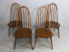 A set of four Ercol elm and beech hoop back dining chairs, with turned legs and H stretchers