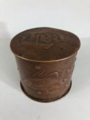 NEWLYN: Copper tea caddy with Lid and repousse decoration of swimming fish with makers mark Newlyn