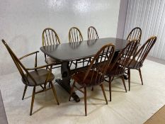 ERCOL elm rounded end dining table on trestle supports, approx 182cm x 89cm. accompanied by eight