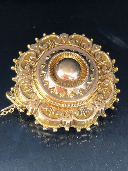 Victorian morning brooch, in gold coloured metal with glass back, safety chain fitted