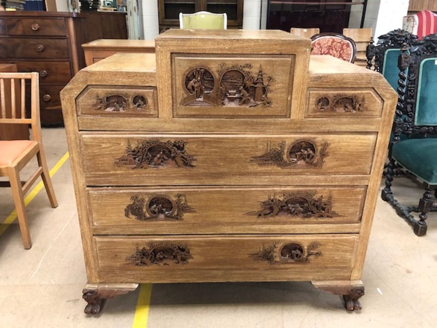 Chest of six drawers in the Oriental style, each end with carved panel, each handle carved with