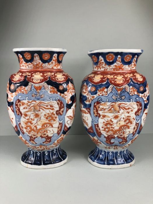 Japanese Imari ware, 2 Imari vases (a pair) painted with designs of Ho Ho birds and symbols of