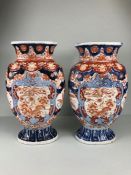 Japanese Imari ware, 2 Imari vases (a pair) painted with designs of Ho Ho birds and symbols of