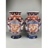 Japanese Imari ware, 2 Imari vases (a pair) painted with designs of Ho Ho birds and symbols of