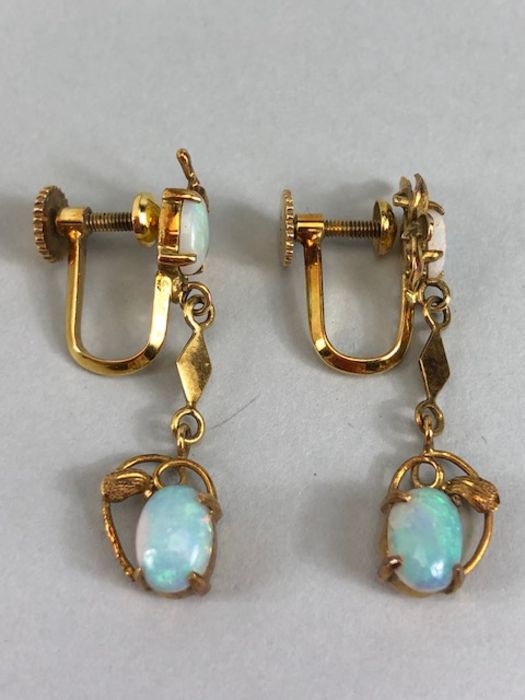 Pair of 14ct Gold drop earrings each set with two cushion cut Opals (total drop approx 32mm)