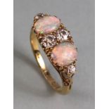 18ct yellow gold Opal and diamond ring, 4 diamonds and 2 Opals in scroll setting approximately 5g