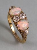 18ct yellow gold Opal and diamond ring, 4 diamonds and 2 Opals in scroll setting approximately 5g