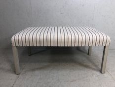 Modern Ottoman seat, upholstered in ticking style fabric on painted legs approximately 120cm x