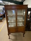 Glass fronted display cabinet with two shelves, cupboard under on queen ann legs