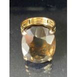 Large faceted smokey Quartz ring on pierced gold band (unmarked) the quartz stone approx 22mm x 16mm