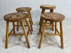 Wooden stools, 4 vintage pine stools with round seats on round tapering legs approximately 45cm high