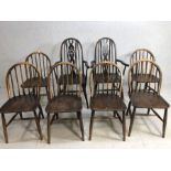 Six stick back Ercol dining chairs, and two wheel back carver chairs