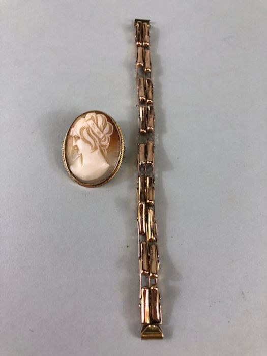 Gold Jewellery, 9ct rose gold watch strap approximately 7.80g and a 9ct gold mounted shell cameo.