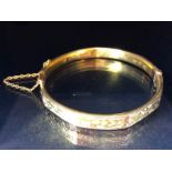 9ct fully hallmarked Gold bangle with floral engraving, good clasp and safety chain total weight