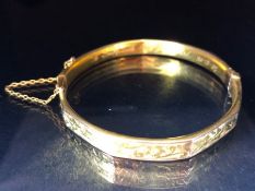 9ct fully hallmarked Gold bangle with floral engraving, good clasp and safety chain total weight