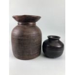 Tribal interest, two Asia turned wooden Ghee pots of classic form the larger approximately 26cm