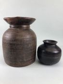 Tribal interest, two Asia turned wooden Ghee pots of classic form the larger approximately 26cm