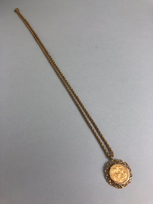 A 1910 Full Gold sovereign in a pierced and scrolling style mount on a Long 9ct Gold chain (approx - Image 7 of 8