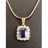18ct sapphire and diamond pendant, cushion cut sapphire surrounded by diamonds on a rolled