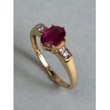 14ct Gold ring set with Oval faceted Ruby in claw setting with pair of diamonds to each shoulder