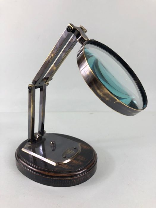 Scientific style magnifying glass on adjustable metal stand with wooden base approximately 28ch
