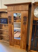 Single wardrobe with door containing bevel edged mirror, carved art deco detailing and original key,