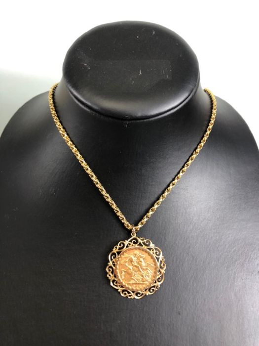 A 1910 Full Gold sovereign in a pierced and scrolling style mount on a Long 9ct Gold chain (approx - Image 8 of 8