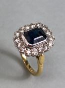 18ct yellow gold cluster ring ,cushion cut sapphire surrounded by diamonds mounted on a 18ct