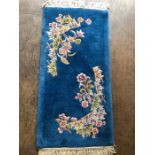 Oriental rug, Chinese wool Rug with pattern of sculpted flowers on a blue background approximately