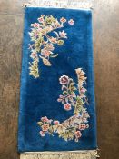 Oriental rug, Chinese wool Rug with pattern of sculpted flowers on a blue background approximately