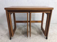 Mid Century A.H. McIntosh & Co Ltd nest of three tables with twist hinged top opening to create